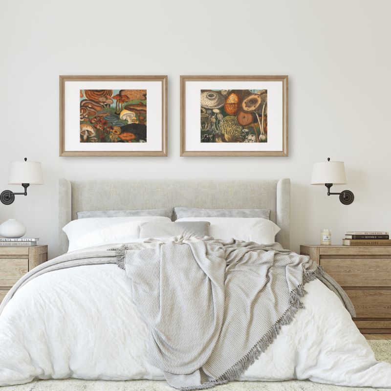 2 art poster sof vintage mushrooms in grass hanging in framed above bed