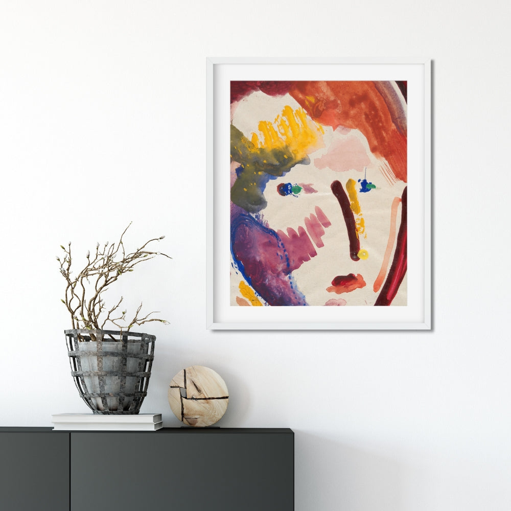 framed abstract colorful face painting hanging on wall