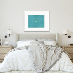 vintage astronomy art print of planets in white frame hanging over bed